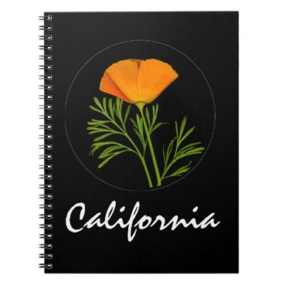 photo of a california poppy and california text on black on a spiral notebook